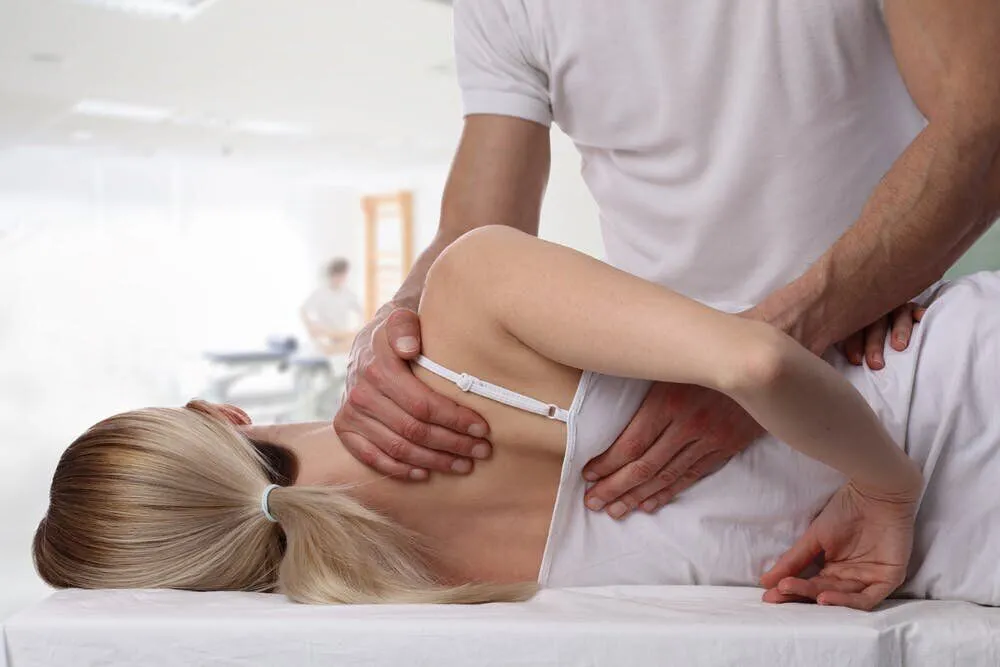 Osteopath providing hands-on shoulder treatment